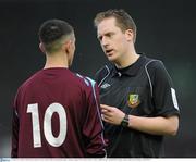 24 April 2010; Referee John Grimes cautions Mervue United's Enda Curran during the game. Airtricity League First Division, Mervue United v Salthill Devon, Terryland Park, Galway. Picture credit: Ray McManus / SPORTSFILE
