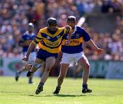 3 June 2001; Sean McMahon of Clare in action against Eddie Enright of Tipperary during the Guinness Munster Senior Hurling Championship Semi-Final match between Tipperary and Clare at Páirc Uí Chaoimh in Cork. Photo by Brendan Moran/Sportsfile