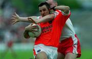 20 May 2001; Barry O'Hagan of Armagh is tackled by Chris Lawn of Tyrone during the Bank of Ireland Ulster Senior Football Championship Quarter-Final match between Tyrone and Armagh at St Tiernach's Park in Clones, Monaghan. Photo by Damien Eagers/Sportsfile