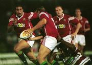 12 June 2001; Rob Henderson of British and Irish Lions lays-off a pass to team-mate Colin Charvis despite the tackle of Junior Pelesas of Queensland President's XV during the match between Queensland President's XV and British and Irish Lions at Dairy Farmers Stadium in Townsville in Queensland, Australia. Photo by Matt Browne/Sportsfile