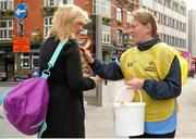 22 April 2016; 3,000 volunteers are out in force across Ireland today, Friday 22nd, trying to raise €650,000 for Special Olympics in just 24 hours. All of the funds raised go towards supporting 9,100 athletes right across Ireland. Collection locations in 250 villages, towns and cities in Ireland. Visit specialolympics.ie to donate and for more details. Pictured is Fiona Byrne, Special Olympics Ireland athlete, right, handing out stickers to donors. Special Olympics Collection Day. Dublin. Picture credit: Seb Daly / SPORTSFILE