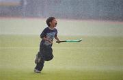 9 May 2010; Kian Fortune, age 7, from Monkstown, gets caught by the sprinklers during half time. Irish Senior Men's Cup Final, Monkstown v Glenanne, National Hockey Stadium, UCD, Belfield, Dublin. Picture credit: Brian Lawless / SPORTSFILE