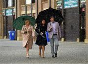 26 April 2016; Racegoers shelter under an umbrella from the weather ahead of the first day's racing at Punchestown Festival. Punchestown, Co. Kildare. Picture credit: Seb Daly / SPORTSFILE