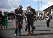 26 April 2016; Two punters study their racecards before the day's racing. Punchestown, Co. Kildare. Photo by Sportsfile