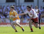 23 May 2010; CJ McGourty, Antrim, in action against Davy Harte, Tyrone. Ulster GAA Football Senior Championship Quarter-Final, Antrim v Tyrone, Casement Park, Belfast, Co. Antrim. Picture credit: Oliver McVeigh / SPORTSFILE