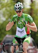 24 May 2010; Conor McConvey, An Post Sean Kelly team, picks up his musette going through the feed station at Ballyconnell, Co. Cavan. FBD Insurance Ras, Stage 2, Dundalk – Carrick-on-Shannon. Picture credit: Stephen McCarthy / SPORTSFILE