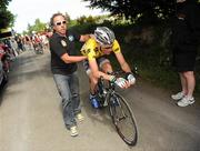 27 May 2010; Race leader Alexander Wetterhall, Team Sprocket Pro Cycling, is held upright following the hill-top finish on Seskin Hill, Co. Tipperary. FBD Insurance Ras, Stage 5, Tipperary - Seskin Hill. Picture credit: Stephen McCarthy / SPORTSFILE