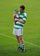 29 May 2010; Graham Denton, Shamrocks, watches the trophy presentation with his three month old nephew Lee Jordan. Leinster GAA Club Hurling League Division 2 Final, Shamrocks, Wexford, v Lucan Sarsfields, Dublin, Nowlan Park, Kilkenny. Picture credit: Ray McManus / SPORTSFILE