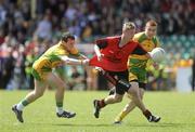 30 May 2010; Caolan Mooney, Down, in action against John O'Malley and Luke Keeney, Donegal. ESB Ulster GAA Football Minor Championship Quarter-Final, Donegal v Down, Mac Cumhail Park, Ballybofey, Co. Donegal. Picture credit: Oliver McVeigh / SPORTSFILE