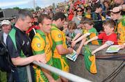 30 May 2010; Michael Murphy, Donegal, signs autographs for young Donegal fans, as team-mate Eamon McGee and manager John Joe Doherty leave the pitch. Ulster GAA Football Senior Championship Quarter-Final, Donegal v Down, Mac Cumhail Park, Ballybofey, Co. Donegal. Picture credit: Oliver McVeigh / SPORTSFILE