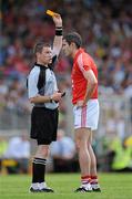 6 June 2010; Cork's Graham Canty is shown a yellow card by referee Padraig Hughes following an incident with Kerry's Colm Cooper. Munster GAA Football Senior Championship Semi-Final, Kerry v Cork, Fitzgerald Stadium, Killarney, Co. Kerry. Picture credit: Brendan Moran / SPORTSFILE