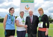 5 June 2010; Laura McSweeney, Colaiste na Toir, Bandon, Co. Cork, in the company of 3rd placed Kate McInerney, St Joseph's, Tulla, Co. Carlow, right, and 2nd placed, Niamh Murphy, Colaiste Choilm, Ballincollig, Co. Cork, is congratulated by Ray Colman, CEO, Woodie's DIY, after winning the Intermediate Girls Shot Putt during the Woodie’s DIY Irish Schools’ Track and Field Championship. Tullamore Harriers Stadium, Tullamore, Co. Offaly. Picture credit: Brendan Moran / SPORTSFILE