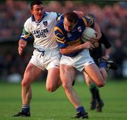 30 May 1998; Brian Burke of Tipperary is tackled by George Walsh of Waterford during the Munster Senior Football Championship Second Round match between Tipperary and Waterford at Ned Hall Park in Clonmel. Photo by Ray McManus/Sportsfile