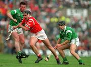 31 May 1998; Kieran Morrisson of Cork is tackled by Mike Houlihan and John Foley of Limerick during the Munster Senior Hurling Championship Quarter-Final match between Limerick and Cork at the Gaelic Grounds in Limerick. Photo by Ray McManus/Sportsfile