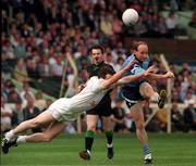 18 June 1994; Tommy Carr of Dublin shoots to score, despite the attempts by Glenn Ryan of Kildare during the Leinster Senior Football Championship Quarter-Final match between Dublin and Kildare at Croke Park in Dublin. Photo by Ray McManus/Sportsfile