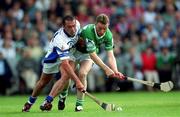 10 June 2001; Peter Queally of Waterford in action against Eoin O'Neill of Limerick during the Guinness Munster Senior Hurling Championship Semi-Final match between Limerick and Waterford at Páirc Uí Chaoimh in Cork. Photo by Brendan Moran/Sportsfile