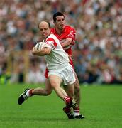 17 June 2001; Peter Canavan of Tyrone is tackled by Jonathan Niblock of Derry during the Bank of Ireland Ulster Senior Football Championship Semi-Final match between Tyrone and Derry at St Tiernach's Park in Clones, Monaghan. Photo by Damien Eagers/Sportsfile