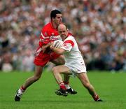 17 June 2001; Peter Canavan of Tyrone is tackled by Jonathan Niblock of Derry during the Bank of Ireland Ulster Senior Football Championship Semi-Final match between Tyrone and Derry at St Tiernach's Park in Clones, Monaghan. Photo by Damien Eagers/Sportsfile