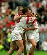 17 June 2001; Cormac McAnallen, centre, Kevin Hughes, left, and Brian McGuigan of Tyrone celebrate their victory of the Bank of Ireland Ulster Senior Football Championship Semi-Final match between Tyrone and Derry at St Tiernach's Park in Clones, Monaghan. Photo by Damien Eagers/Sportsfile