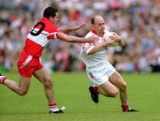 17 June 2001; Peter Canavan of Tyrone in action against Jonathan Niblock of Derry during the Bank of Ireland Ulster Senior Football Championship Semi-Final match between Tyrone and Derry at St Tiernach's Park in Clones, Monaghan. Photo by Damien Eagers/Sportsfile