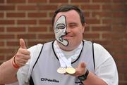 12 June 2010; Christopher McKinstry, from Belfast, Co. Antrim, sporting a maori face painting, celebrates with his gold and silver athletics medals during the 2010 Special Olympics Ireland Games. University of Limerick, Limerick. Picture credit: Diarmuid Greene / SPORTSFILE