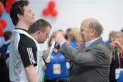 12 June 2010; Michael Noonan T.D., presents a medal during the Gymnastics medal presentation during the third day of the 2010 Special Olympics Ireland Games. University of Limerick, Limerick. Picture credit: Stephen McCarthy / SPORTSFILE