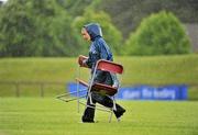 13 June 2010; Voulenteer Croidh Fitzgerald, from Newmarket, Clare, goes for cover during a downpour during the final day of the 2010 Special Olympics Ireland Games. University of Limerick, Limerick. Picture credit: Stephen McCarthy / SPORTSFILE
