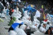 13 June 2010; Spectators take shelter during the heavy rain. Leinster GAA Football Senior Championship Quarter-Final, Meath v Laois, Croke Park, Dublin. Picture credit: David Maher / SPORTSFILE