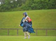 13 June 2010; Voulenteer Carmel Howard, from Shannon, Limerick, makes her way across the infield amid a shower of rain during the final day of the 2010 Special Olympics Ireland Games. University of Limerick, Limerick. Picture credit: Stephen McCarthy / SPORTSFILE