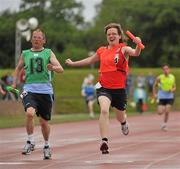 13 June 2010; Rachel Ryan, Tipperary, red bib, and John Naughton, Irishtown, Dublin, complete the final leg of the 4x100m relay for his Munster and Eastern Region teams during the final day of the 2010 Special Olympics Ireland Games. University of Limerick, Limerick. Picture credit: Stephen McCarthy / SPORTSFILE