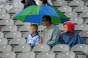 13 June 2010; Dublin fans take cover from the rain. Leinster GAA Football Senior Championship Quarter-Final, Dublin v Wexford, Croke Park, Dublin. Picture credit: Barry Cregg / SPORTSFILE