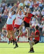 19 June 2010; Brian McGuigan and Kevin Hughes, Tyrone, in action against Ambrose Rogers, Down. Ulster GAA Football Senior Championship Semi-Final, Tyrone v Down, Casement Park, Belfast, Co. Antrim. Picture credit: Oliver McVeigh / SPORTSFILE