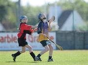 20 June 2010; Michelle Connors, Killanena, Co. Clare, in action against Clodagh Walsh, Cillard, Co. Kerry, Division 4 Camogie Final. Coca-Cola GAA Féile na nGael Finals 2010. Clarecastle, Co. Clare. Picture credit: Diarmuid Greene / SPORTSFILE