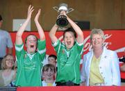 20 June 2010; Lucan Sarsfields, Dublin, captain Anne Marie Courtney, alongside team-mate Laura Morrissey, left, and Joan O'Flynn, President of Cumann Camogaiochta na nGael, lifts the Corn Ui Phuirseil trophy after victory over Burgess-Duharra, Tipperary. Coca-Cola GAA Féile na nGael Finals 2010, Division 1 Camogie Final. Cusack Park, Ennis, Co. Clare. Picture credit: Diarmuid Greene / SPORTSFILE