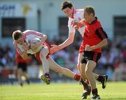 19 June 2010; Stefan Tierney and Conor Clarke, Tyrone, in action against Caolan Mooney, Down. Ulster GAA Football Minor Championship Semi-Final, Tyrone v Down, Casement Park, Belfast, Co. Antrim. Picture credit: Oliver McVeigh / SPORTSFILE