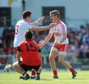 19 June 2010; Conor Clarke and Richard Donnelly, Tyrone, celebrate at the end of the game as Rya O'Hare, Down, looks on. Ulster GAA Football Minor Championship Semi-Final, Tyrone v Down, Casement Park, Belfast, Co. Antrim. Picture credit: Oliver McVeigh / SPORTSFILE