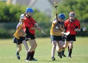 20 June 2010; Aine O'Connor, Cillard, Co. Kerry, in action against Claire Taffe and Eimear Noonan, left, Killanena, Co. Clare, Division 4 Camogie Final. Coca-Cola GAA Féile na nGael Finals 2010. Clarecastle, Co. Clare. Picture credit: Diarmuid Greene / SPORTSFILE