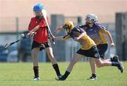 20 June 2010; Aine O'Connor, Cillard, Co. Kerry, in action against Lorraine Canny and Catherine McMahon, right, Killanena, Co. Clare, Division 4 Camogie Final. Coca-Cola GAA Féile na nGael Finals 2010. Clarecastle, Co. Clare. Picture credit: Diarmuid Greene / SPORTSFILE