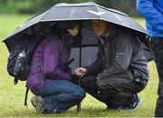 22 May 2016; Spectators shelter after play was suspended due to bad weather during the final round of the Dubai Duty Free Irish Open Golf Championship at The K Club in Straffan, Co. Kildare. Photo by Matt Browne/Sportsfile