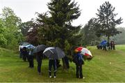22 May 2016; Spectators shelter after play was suspended due to bad weather during the final round of the Dubai Duty Free Irish Open Golf Championship at The K Club in Straffan, Co. Kildare. Photo by Matt Browne/Sportsfile
