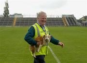 22 May 2016; O'Connor Park steward Jim Kelly escorts a stray dog off the pitch before the Leinster GAA Hurling Championship Qualifier,  Round 3, between Offaly and Kerry at O'Connor Park, Tullamore, Co. Offaly.  Photo by Piaras Ó Mídheach/Sportsfile