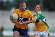 26 June 2010; Ger Quinlan, Clare, holds off the challenge of Anton Sullivan, Offaly. GAA Football All-Ireland Senior Championship Qualifier Round 1, Offaly v Clare, O'Connor Park, Tullamore, Co. Offaly. Picture credit: Brendan Moran / SPORTSFILE