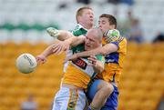 26 June 2010; Offaly goalkeeper Alan Mulhall, left, and full-back Scott Brady contest a high ball with Gary Brennan, Clare. GAA Football All-Ireland Senior Championship Qualifier Round 1, Offaly v Clare, O'Connor Park, Tullamore, Co. Offaly. Picture credit: Brendan Moran / SPORTSFILE