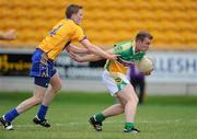 26 June 2010; David Egan, Offaly, holds off the challenge of Brian Carrig, Clare, on the way to scoring his side's first goal. GAA Football All-Ireland Senior Championship Qualifier Round 1, Offaly v Clare, O'Connor Park, Tullamore, Co. Offaly. Picture credit: Brendan Moran / SPORTSFILE