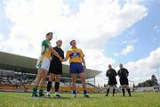 26 June 2010; Team captains Karol Slattery, left, Offaly, and Gordon Kelly, Clare, shake hands in front of referee Martin Higgins as linesmen Derek O'Mahony and Declan Hunt look on. GAA Football All-Ireland Senior Championship Qualifier Round 1, Offaly v Clare, O'Connor Park, Tullamore, Co. Offaly. Picture credit: Brendan Moran / SPORTSFILE