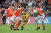 26 June 2010; Barry Dunnion, Donegal, in action against Vincent Martin and Brendan Donaghy, Armagh. GAA Football All-Ireland Senior Championship Qualifier Round 1, Armagh v Donegal, Crossmaglen, Co. Armagh. Picture credit: Oliver McVeigh / SPORTSFILE