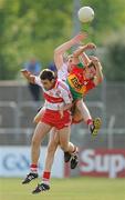 26 June 2010; Enda Muldoon, right, and Cathal McKeever, Derry, in action against Sean Gannon, Carlow. GAA Football All-Ireland Senior Championship Qualifier Round 1, Carlow v Derry, Dr. Cullen Park, Carlow. Photo by Sportsfile