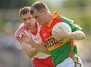 26 June 2010; Mark Carpenter, Carlow, in action against Enda Muldoon, Derry. GAA Football All-Ireland Senior Championship Qualifier Round 1, Carlow v Derry, Dr. Cullen Park, Carlow. Photo by Sportsfile