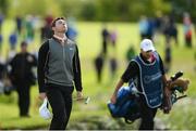 22 May 2016; Rory McIlroy of Northern Ireland reacts, alongside his caddy JP Fitzgerald, as he walks to his ball on the 18th green during the final round of the Dubai Duty Free Irish Open Golf Championship at The K Club in Straffan, Co. Kildare. Photo by Diarmuid Greene/Sportsfile