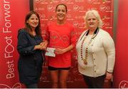22 May 2016; Orla Drumm, centre, is presented with her prize by Karen O'Connor, left, Virgin Media Senior Marketing Manager, and Georgina Drumm, right, President Athletics Association of Ireland, after finishing second in the female category during the 2016 Virgin Media Night Run in Dublin City Centre, Dublin.  Photo by Seb Daly/Sportsfile